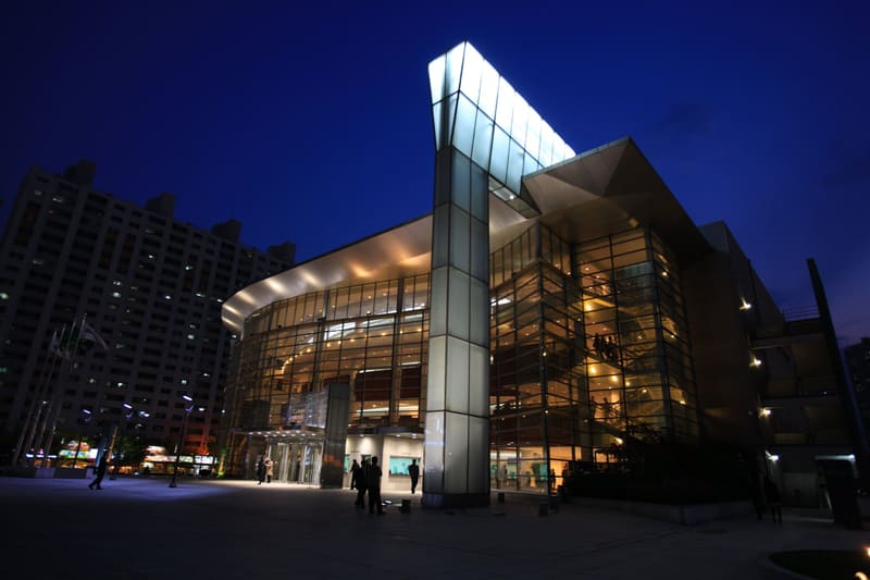 Daegu Opera House lit up at dusk, one of the theatres the festival has used in earlier years