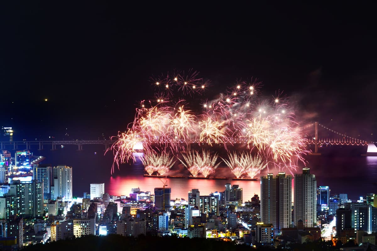 Fireworks over Gwangan Bridge seen from a hillside above the city's apartment towers, 2017