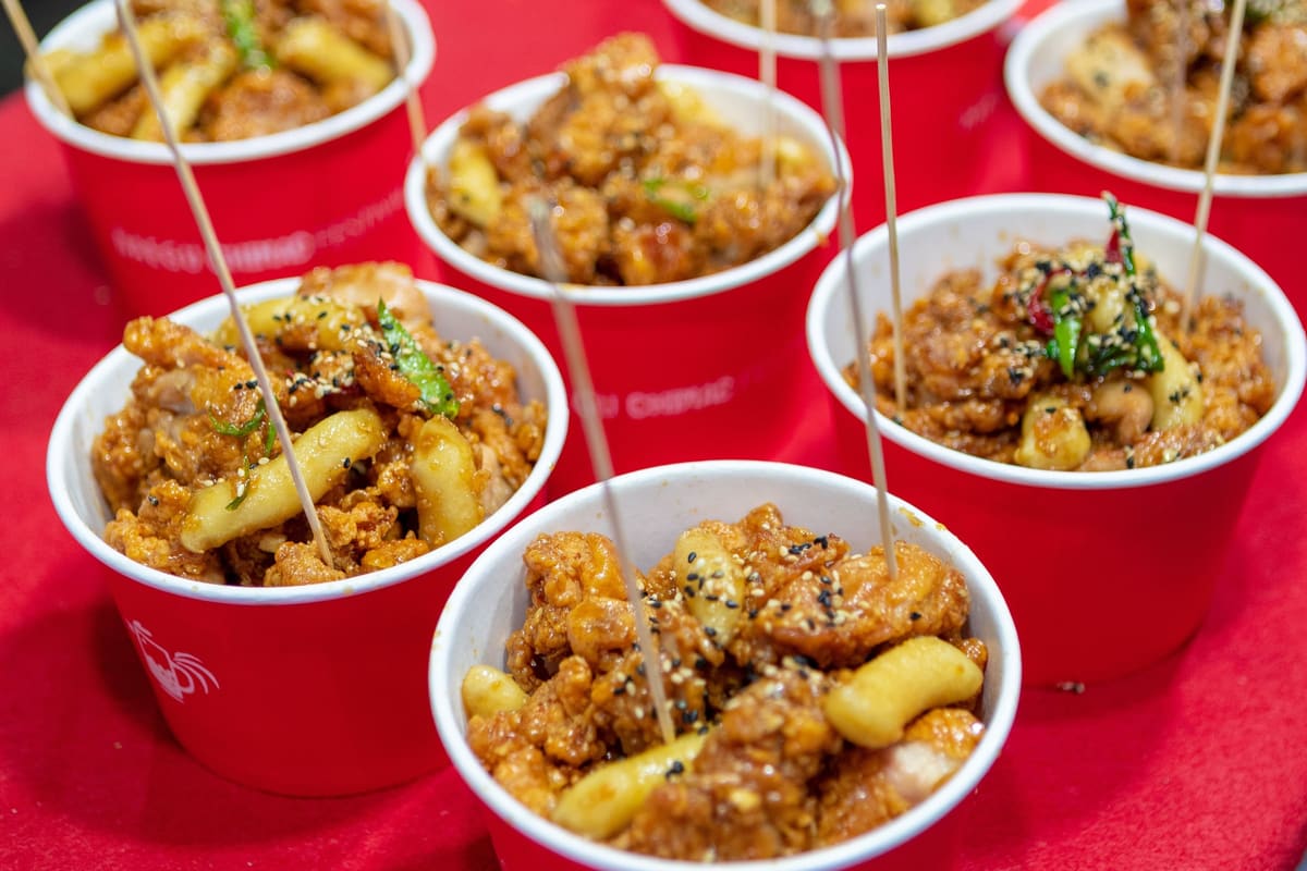 Cups of sauced fried chicken and rice cakes with toothpicks at the 2018 Daegu Chimac Festival