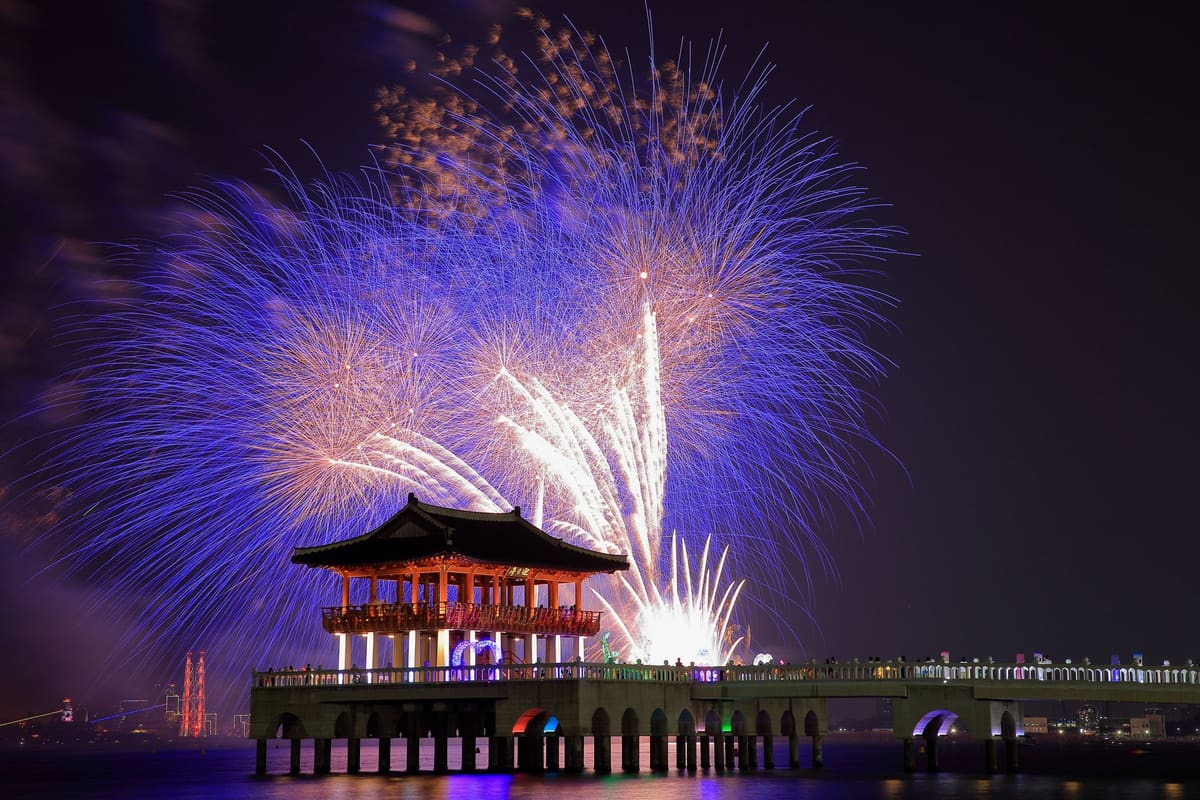 Fireworks bursting behind the Yeongildae pavilion on its pier, 2017