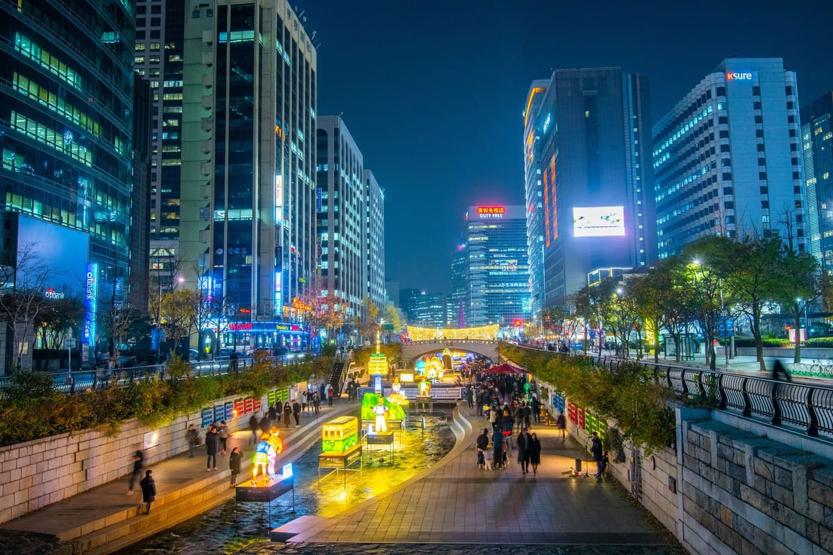 Lanterns along Cheonggyecheon stream between the office towers of central Seoul, seen from a bridge in November 2018