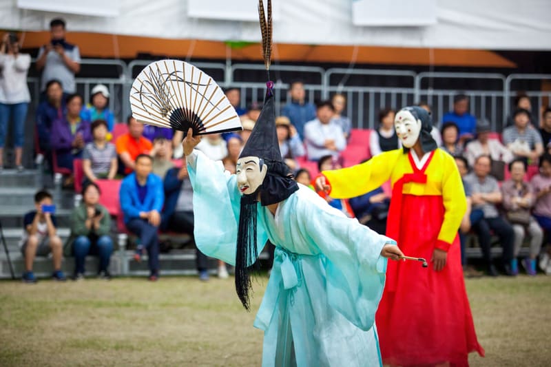 Masked performers staging the Gwanno mask drama, a Gangneung Danoje tradition, in front of an audience