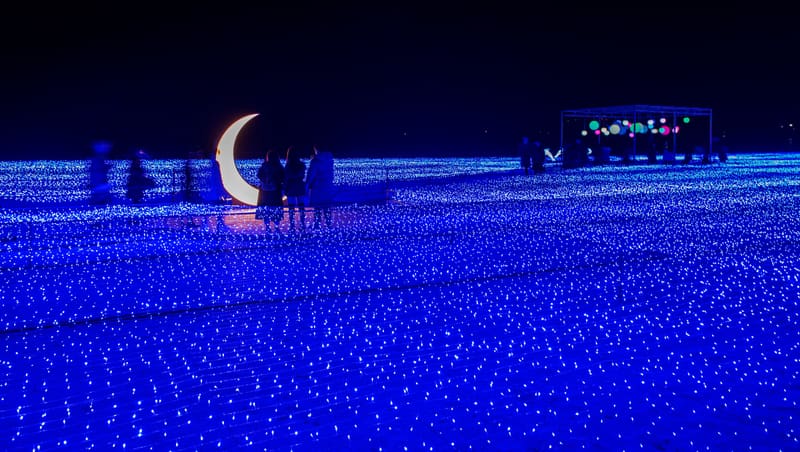 A carpet of blue lights across Haeundae Beach with a glowing crescent moon at the 2020 Haeundae Light Festival