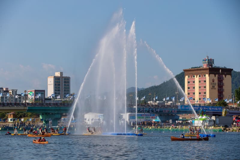 Water jets and canoes on the Tamjin River during the 2018 Jeongnamjin Jangheung Water Festival