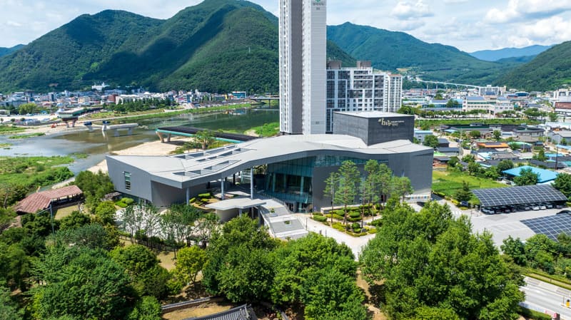 Aerial view of the Arirang Center in Jeongseon-eup, the town where the festival is held, with mountains behind